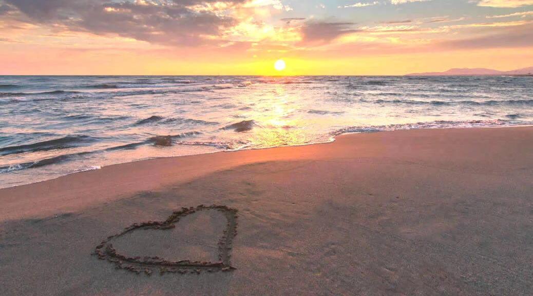 Heart in Beach Sand at Sunrise