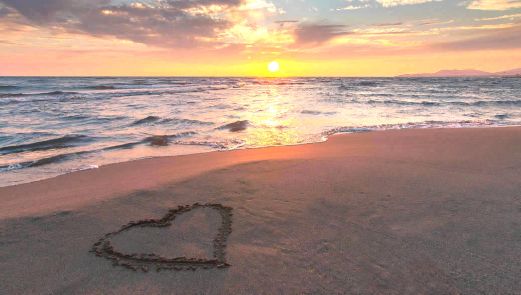 Heart in Beach Sand at Sunrise